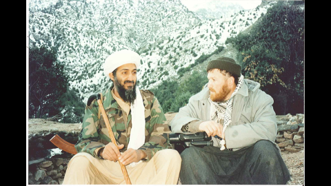 Osama bin Laden, with his Kalashnikov rifle, sits at the base of a Tora Bora mountain with Syrian-born ideologue Abu Musab al-Suri.