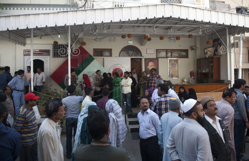Pakistani supporters of MQM political party gather outside party  headquarters following a raid by paramilitary Rangers in Karachi. 