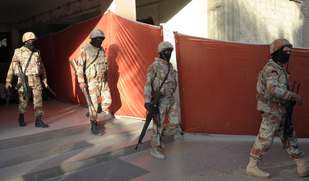Pakistani paramilitary soldiers leave the headquarters of the MQM political party after a raid in Karachi. 