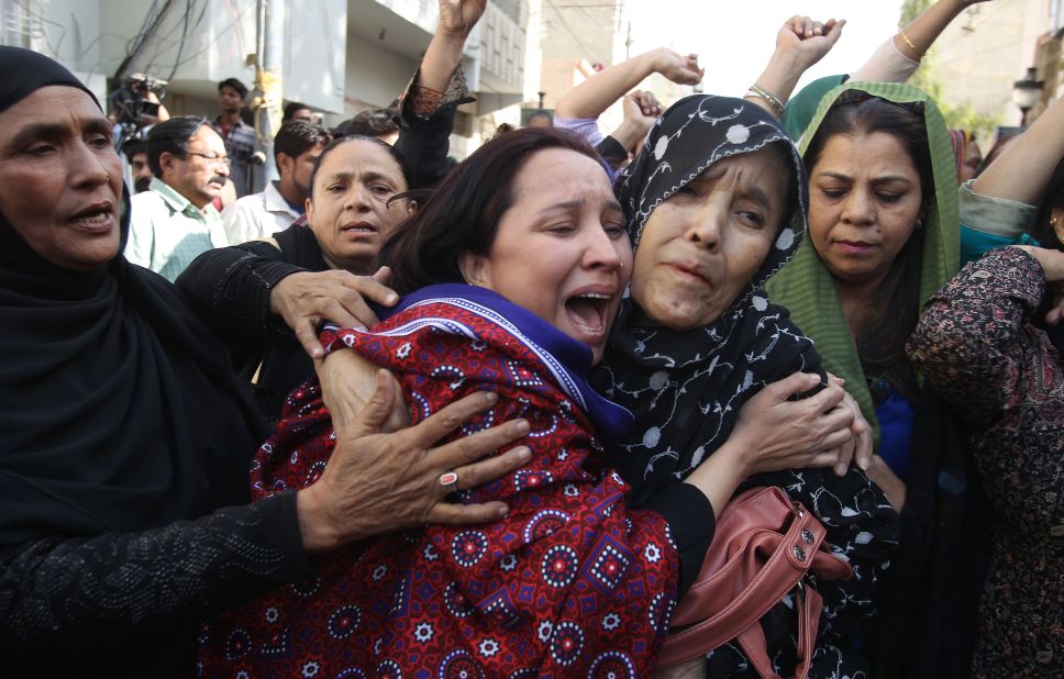 Pakistani women react to the arrest of their family members during a raid at the offices of the MQM headquarters in Karachi.