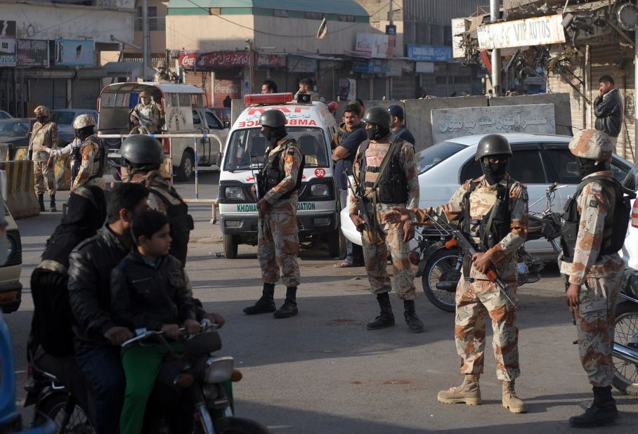 Pakistani paramilitary soldiers cordon off a street during a raid on the offices of MQM political party in Karachi.  