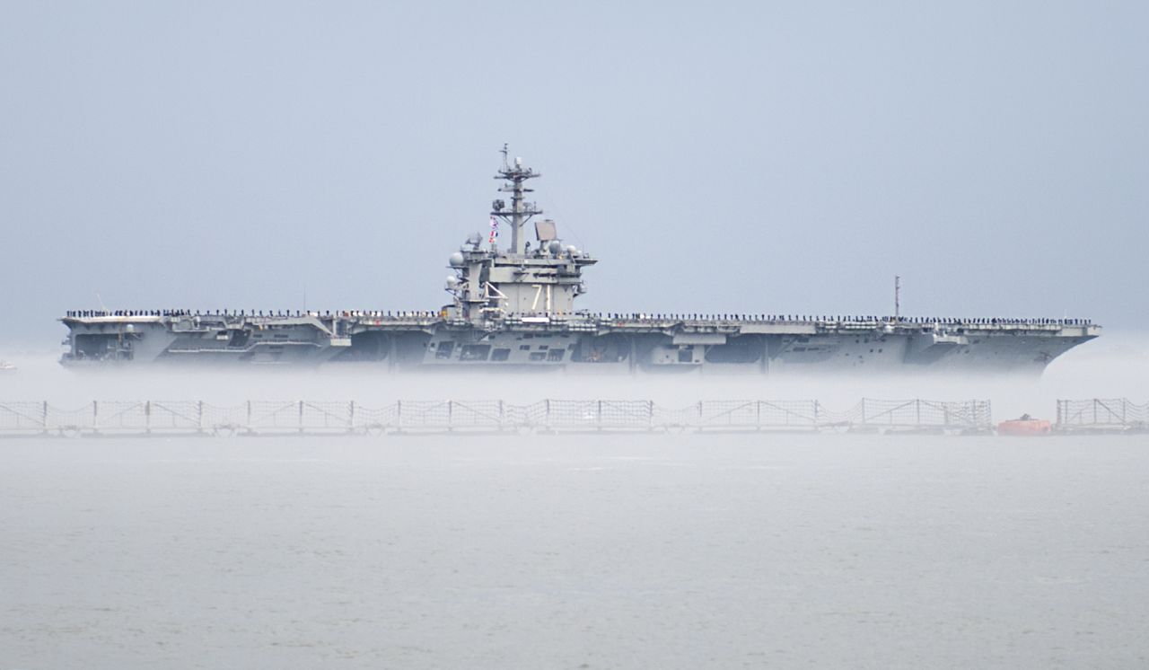 The aircraft carrier USS Theodore Roosevelt departs Naval Station Norfolk, Virginia, on Wednesday, March 11, for a scheduled deployment. The Nimitz-class carrier's departure was delayed for two days after marine growth clogged sea water intakes. Divers went into the 36-degree water to clean out the intakes and allow the ship to get under way. The cold water created a fog that made it seem the ship was in a cloud.
