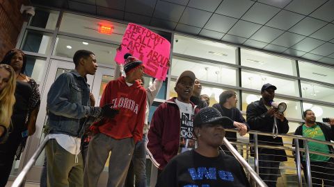 Protesters demonstrate outside the police station on Wednesday, March 11. Some gathered to cheer the resignation of police Chief Thomas Jackson. Others amassed to demand more: the disbanding of the entire police department and the resignation of Mayor James Knowles.