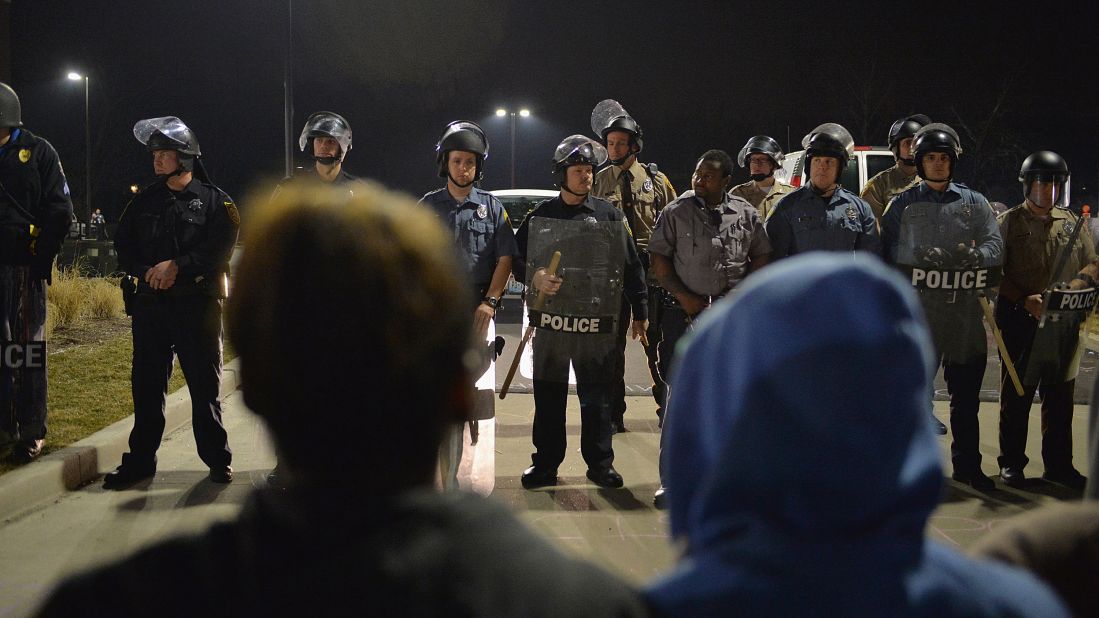 Police officers stand on alert during the protests on March 11.