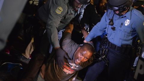 A demonstrator is detained and arrested during the March 11 protest.