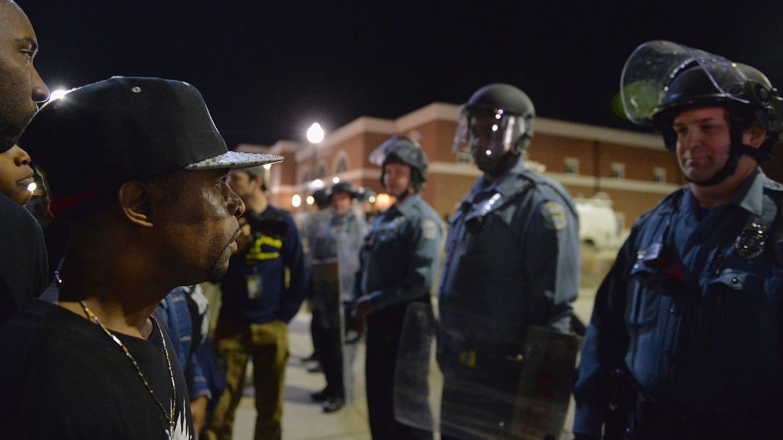 Protesters face off with Ferguson police officers on March 11.