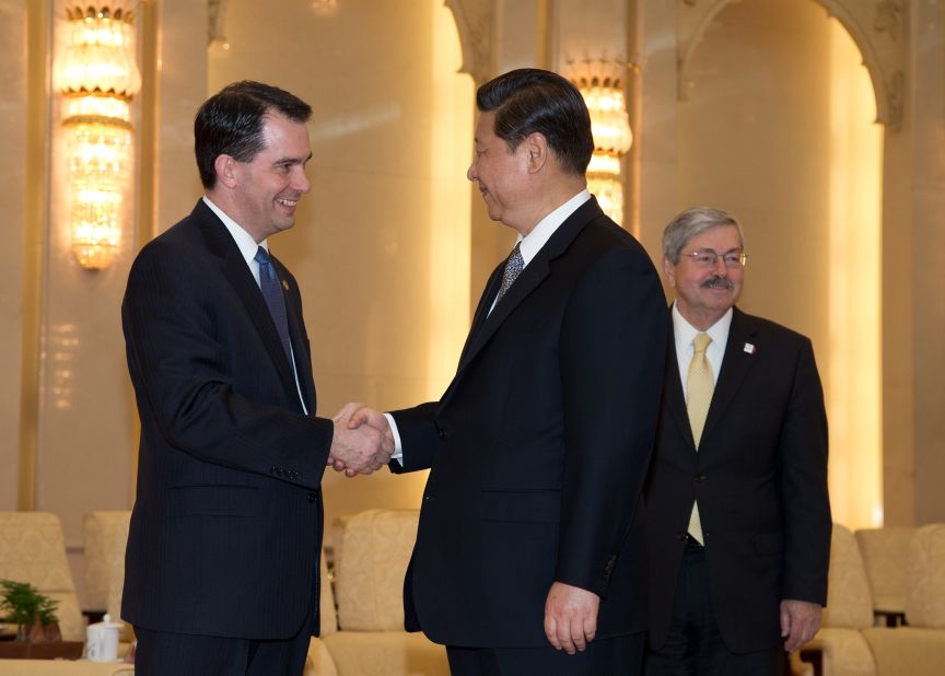 Scott Walker (left) shakes hands with Chinese President Xi Jinping (center) before a meeting as Iowa Governor Terry Branstad (right) looks on at the Great Hall of the People in Beijing on April 15, 2013.