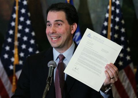 Walker holds a letter from democratic State Sen. Mark Miller, one of the fourteen Wisconsin state senators who fled the state over two weeks ago, during a press conference on March 7, 2011, in Madison, Wisconsin.