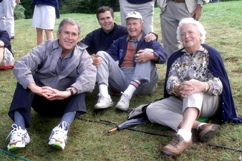 The Bush family, (left to right) former U.S. President George W., former Florida Governor Jeb, former President George H.W. and his wife Barbara, watch play during the Foursomes matches September 25, 1999 at The Country Club in Brookline, Massachusetts the site of the 33rd Ryder Cup Matches. 