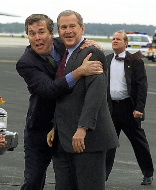 Then-President George W. Bush (right) is greeted by Jeb Bush on March 21, 2001, at Orlando International Airport in Orlando, Florida. President Bush was in Orlando to attend the American College of Cardiology Annual Convention.