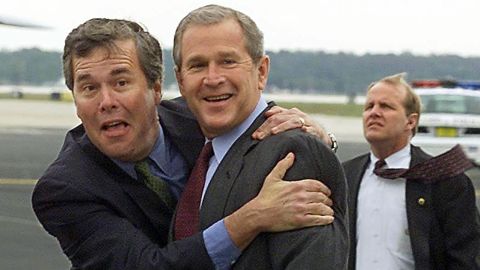 Former U.S. President George W. Bush (right) is greeted by his brother, Florida Governor Jeb Bush on March 21, 2001 at Orlando International Airport in Orlando, Florida. President Bush was in Orlando to attend the American College of Cardiology Annual Convention.