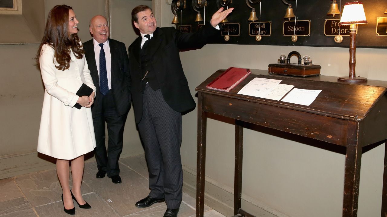 Catherine, Duchess of Cambridge is shown the Downton Abbey servants bells by actor Brendan Coyle (John Bates) during an official visit to the set of Downton Abbey at Ealing Studios on March 12, 2015 in London, England.
