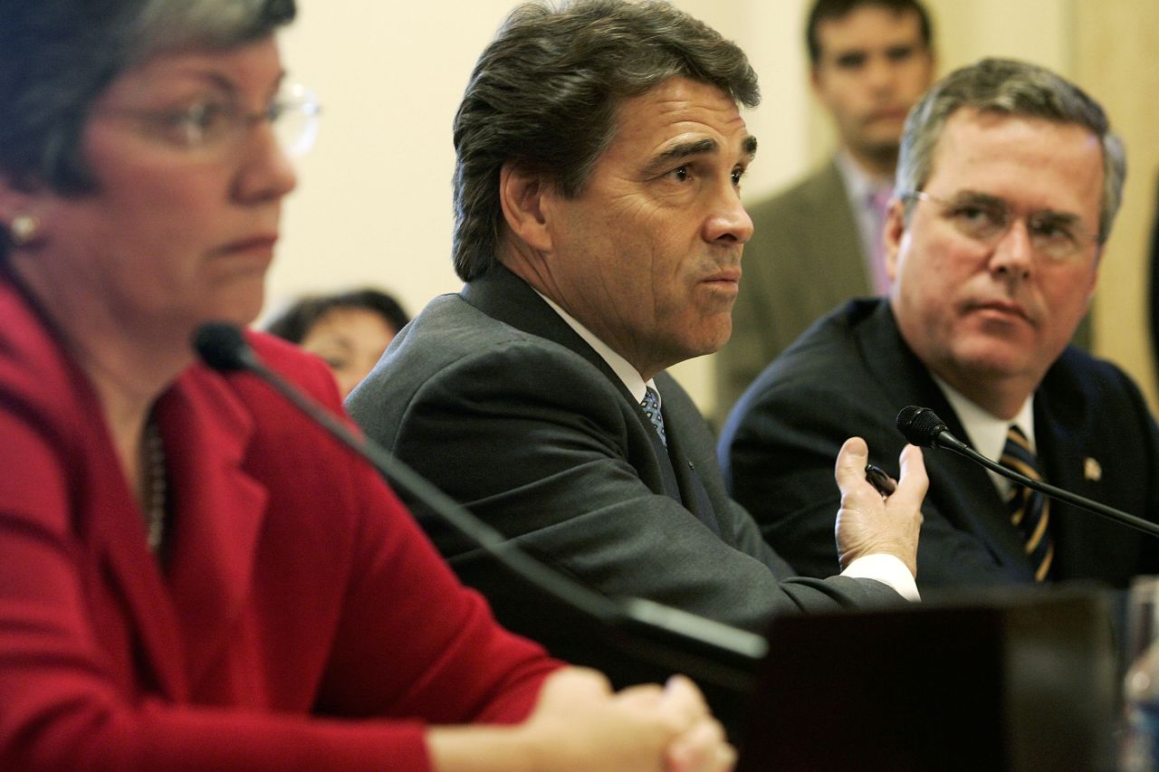 Then-Texas Governor Rick Perry (center) testifies as Bush (right) and then-Arizona Governor Janet Napolitano (left) listen during a hearing before the House Committee on Homeland Security on Capitol Hill October 19, 2005.