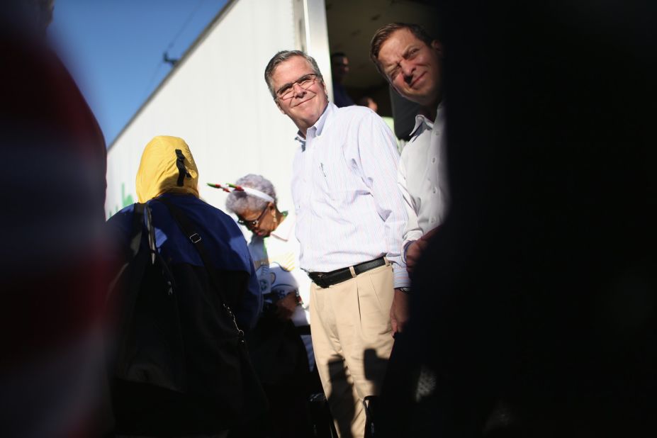 Bush hands out items for Holiday Food Baskets to those in need outside the Little Havana offices of CAMACOL, the Latin American Chamber of Commerce on December 17 in Miami.