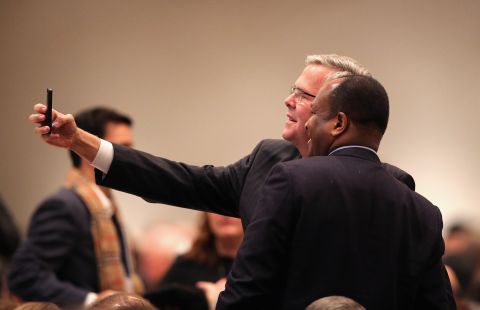 Bush takes a selfie with a guest at a luncheon hosted by the Chicago Council on Global Affairs on February 18 in Chicago. Bush delivered his first major foreign policy speech at the event.