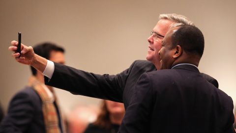 Bush takes a selfie with a guest at a luncheon hosted by the Chicago Council on Global Affairs on February 18 in Chicago. Bush delivered his first major foreign policy speech at the event.