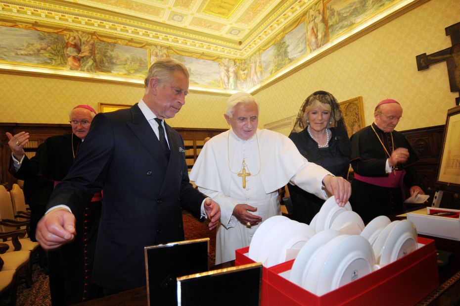 Pope Benedict XVI exchanges gifts with Charles and Camilla as they meet in his private library at the Vatican in April 2009. 
