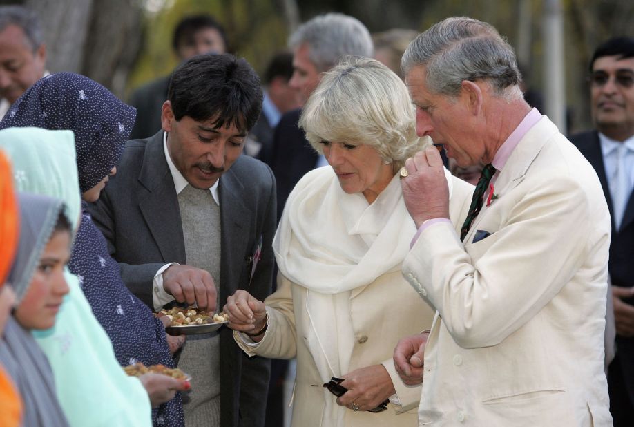 Charles and Camilla taste local food during a visit to Skardu, Pakistan, in November 2006.