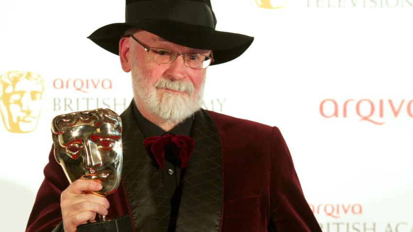 Winner of Best Single Documentary Terry Pratchett poses in front of the winners boards at the British Academy Television Awards at the Royal Festival Hall in London, on May 27, 2012.     AFP PHOTO/ ANDREW COWIE        (Photo credit should read Andrew Cowie/AFP/GettyImages)
