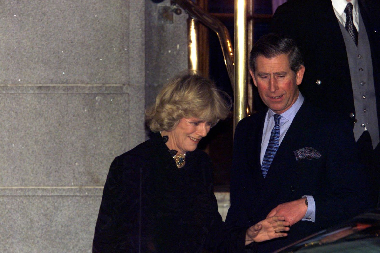 Charles and Camilla make their first public appearance as a couple after leaving a party in London in January 1999.