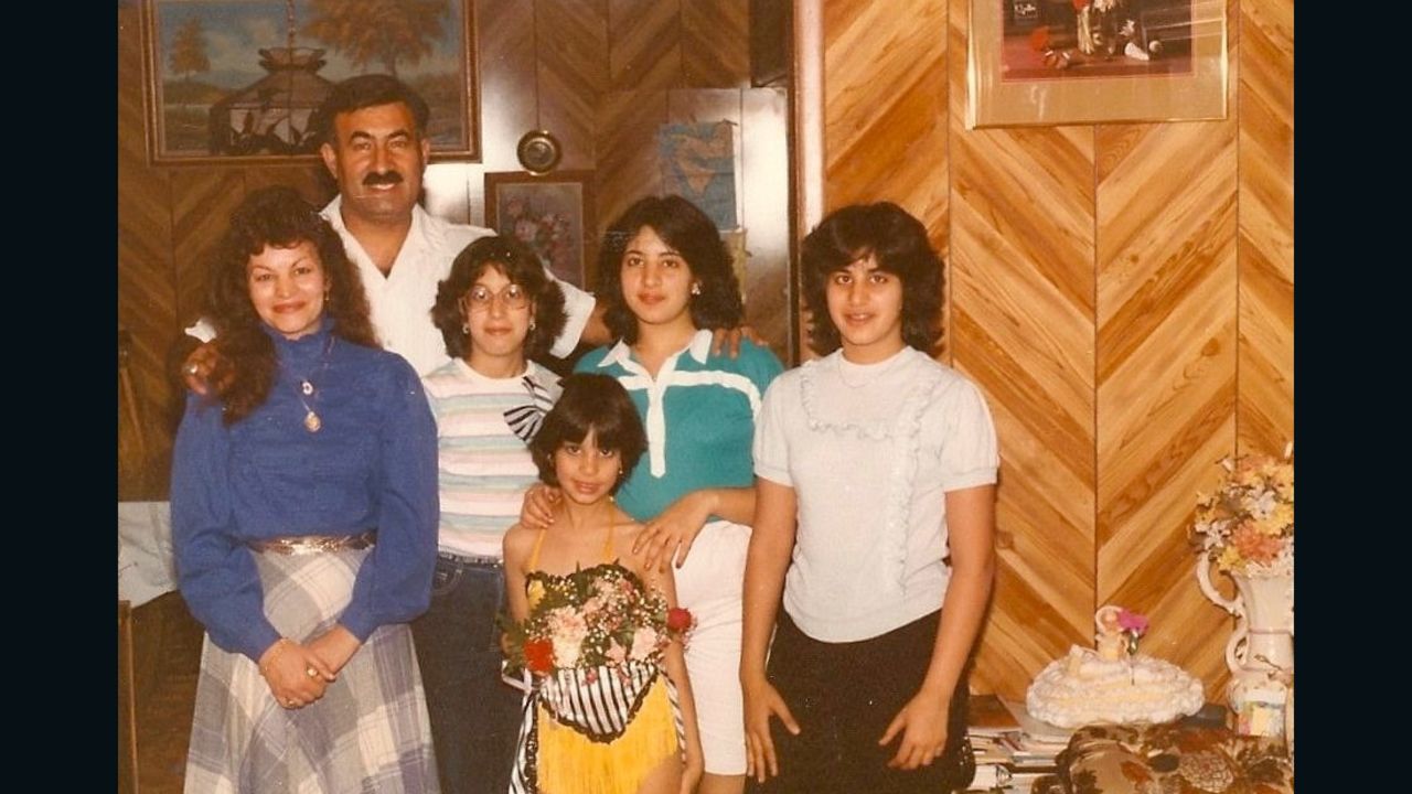 Dressed in a dancing costume, Zayid poses with her parents and siblings.