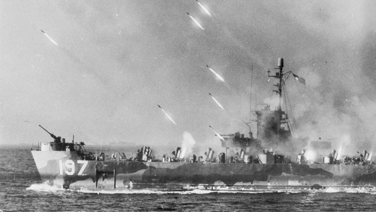 Spring 1945: Rockets from an American warship stream toward Okinawa Island prior to the invasion by U.S. forces.