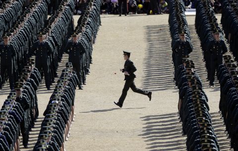 MARCH 12 - GYERYONG, SOUTH KOREA: A military officer runs to his position during the joint commission ceremony of thousands of new military officers of the army, navy, air force and marines at the military headquarters.