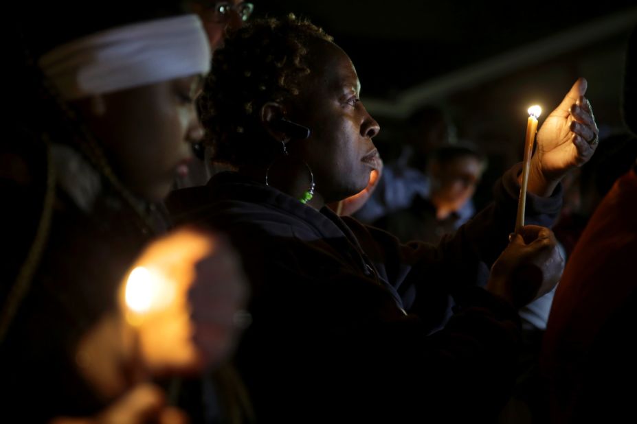 People take part in a candlelight vigil Thursday, March 12, in Ferguson, Missouri.