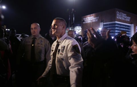 St. Louis County police Lt. Jerry Lohr walks through a crowd of protesters in Ferguson on March 12, trying to get them to move out of the street. The St. Louis County police said it had assumed "command of the security detail regarding protests," together with the Missouri State Highway Patrol. 