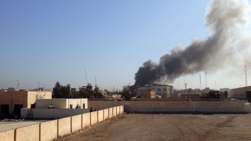 Caption:A picture taken on March 11, 2015 shows smoke billowing after the building of the Anbar Governorate was hit by a mortar shell in the Hosh district of Ramadi as the Islamic State jihadist group launched a coordinated attack on government-held areas of the western Iraqi city, involving seven almost simultaneous suicide car bombs, police said. At least 10 people were killed and 30 wounded in the attack, according to initial reports by police and hospital sources in the city, capital of Anbar province. AFP PHOTO / AZHAR SHALLAL (Photo credit should read AZHAR SHALLAL/AFP/Getty Images)