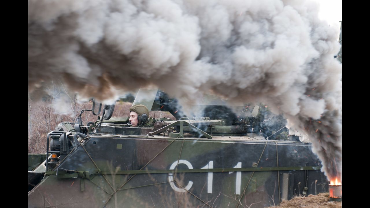 A Lithuanian soldier from 3rd Company, Algirdas Mechanized Infantry Battalion waits in an M113 armored personnel carrier during a combined live-fire exercise with U.S. troops at Pabrade training area, Lithuania, March 4, 2015.