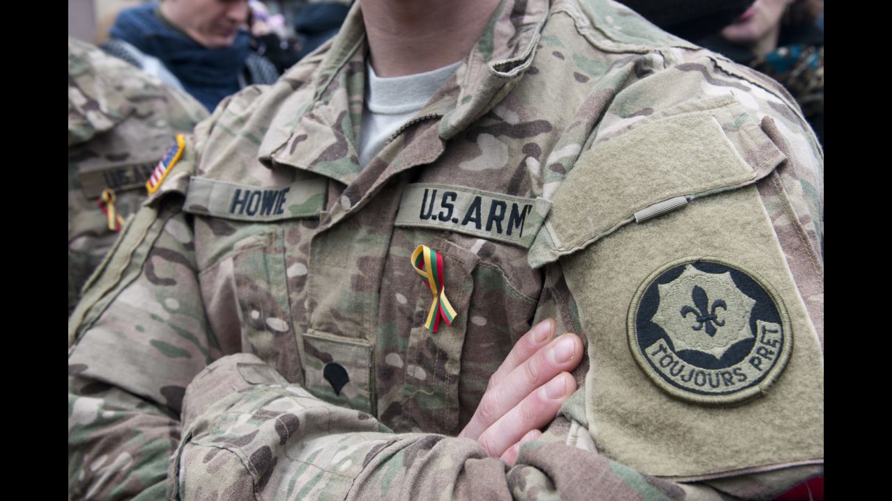 Dragoons from Lightning Troop, 3rd Squadron, 2nd Cavalry Regiment participate in Operation Atlantic Resolve. They wear ribbons representing the Lithuanian flag during an Independence Day event in Vilnius, Lithuania, March 11, 2015.