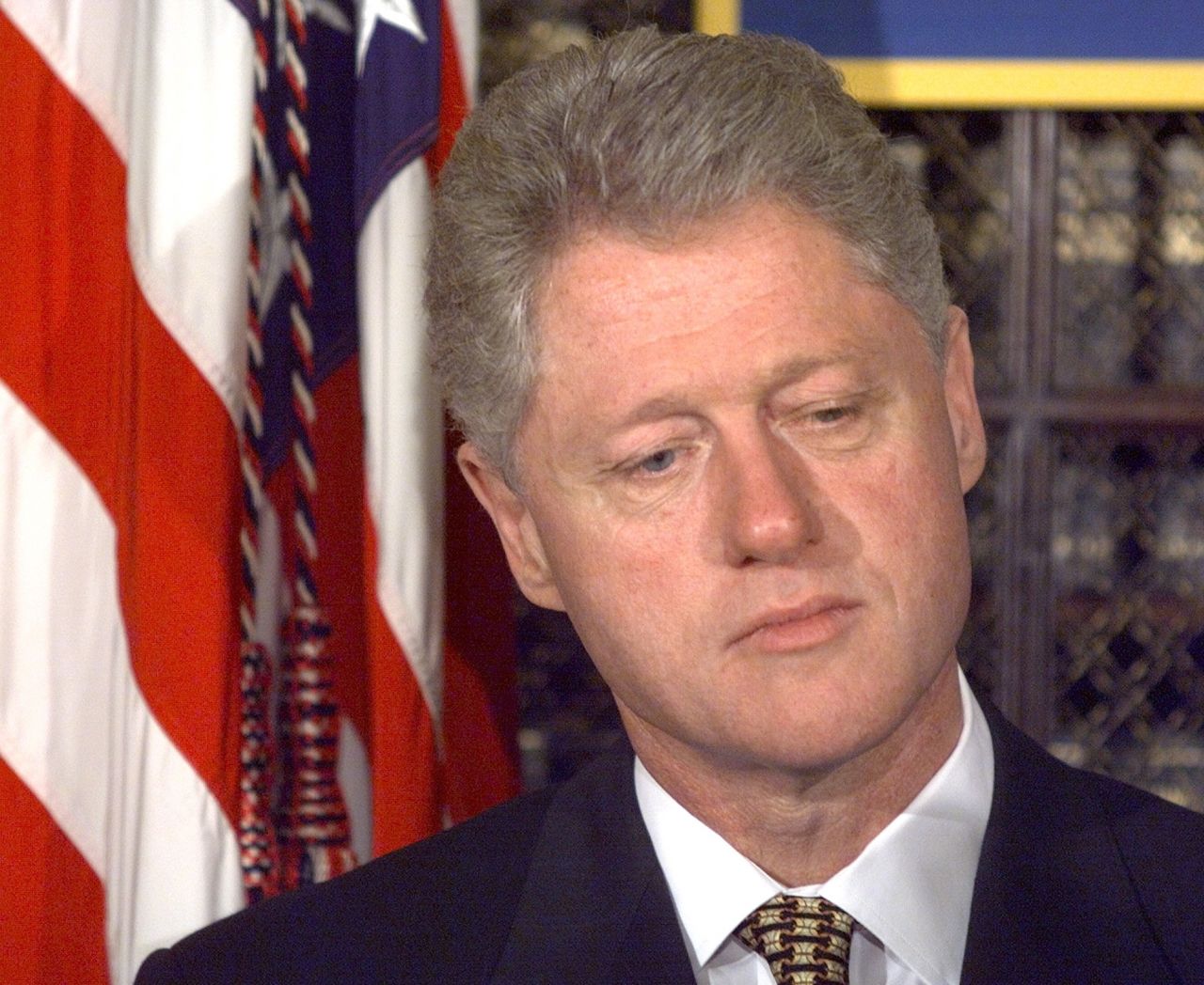 Former President Clinton stands to the side as he waits to be introduced at an event at the White House on October 8, 1998. Later that afternoon, the Republican House majority adopted a motion to launch an impeachment inquiry into Clinton's presidency.