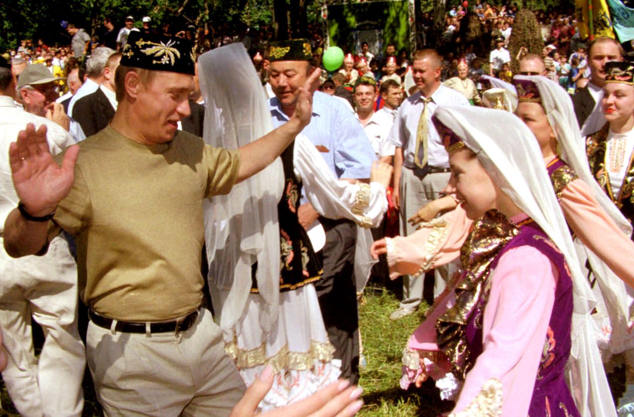 Putin dances with a young girl in Kazan, Russia, while taking part in midsummer festivities in June 2000.