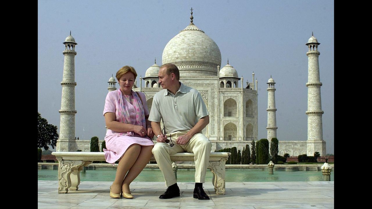 Putin speaks to his wife, Lyudmila, as they pose in front of the Taj Mahal in India in October 2000.