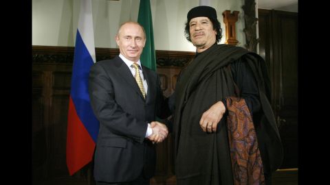 Putin shakes hands with Libyan leader Moammar Gadhafi in November 2008.