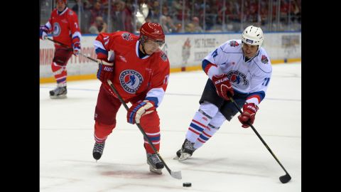 Putin controls the puck during an ice hockey game between Russian amateur players and ice hockey stars at a festival in Sochi, Russia, in May 2014.