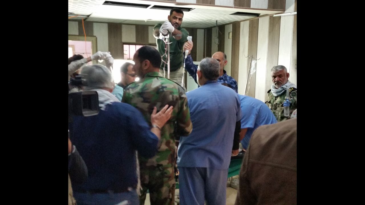 Medical personnel at Tikrit's Dijla Hospital work to save the life of a wounded man, their efforts in vain.
