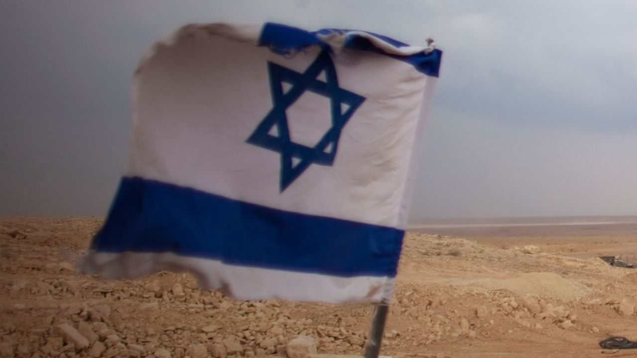 An Israeli flag flies at a desert checkpoint