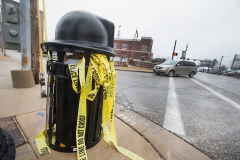 Crime scene tape used to secure the area after two officers were shot outside the Ferguson police station, sits in a trash can on March 13.