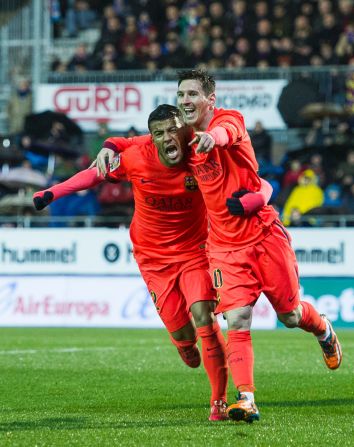 Lionel Messi celebrates with Barcelona teammate Rafinha after scoring one of his two goals against Eibar on Saturday.