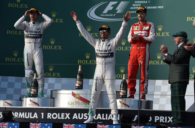 Hamilton celebrates on the podium with his teammate Rosberg and four-time world champion Sebastian Vettel of Ferrari.
