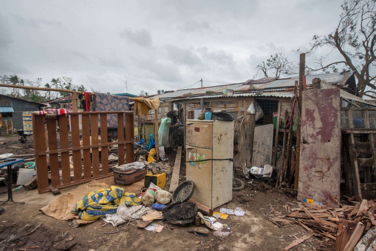 A resident stands in her badly damaged home outside Port Vila on March 15. 