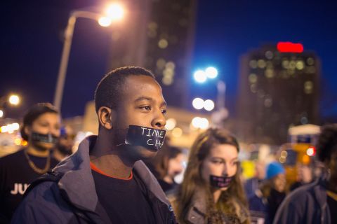 A protester with a taped mouth marches through downtown St. Louis on March 14. 