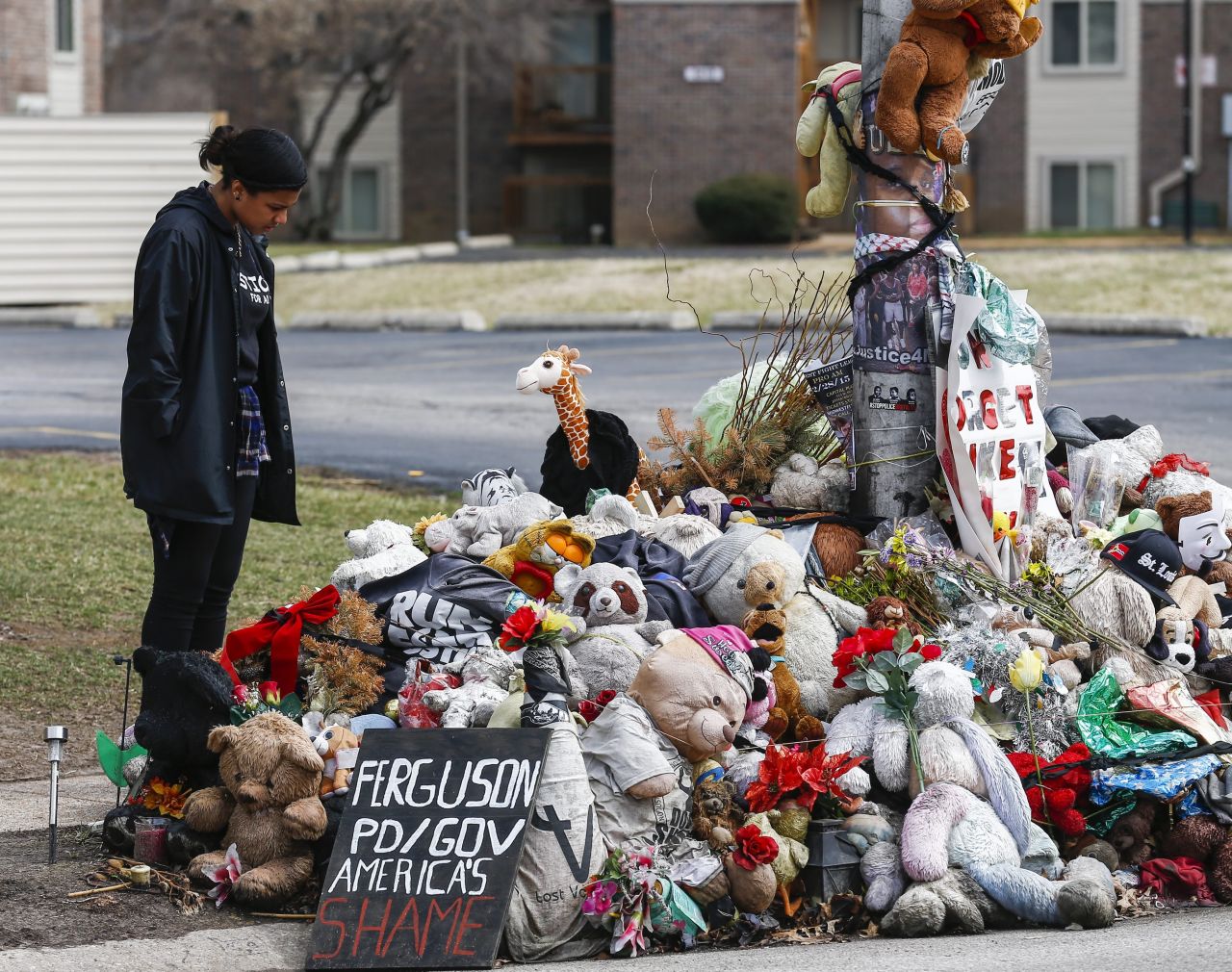 Suzanne Del Rosario pauses as she visits the memorial at the location of the shooting death of Michael Brown in Ferguson, Missouri, on March 15.