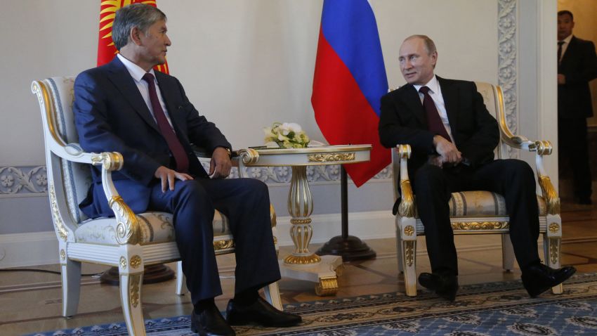 Russian President Vladimir Putin, right, and Kyrgyz President Almazbek Atambayev speak during their meeting in the Konstantin Palace outside St. Petersburg, Russia, Monday, March 16, 2015. Putin resurfaced Monday after a 10-day absence from public view, looking healthy. (AP Photo/Anatoly Maltsev, Pool)