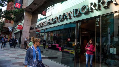 A woman exits the headquarters of Banca Privada d'Andorra in October. The bank is accused of "washing" dirty cash. 