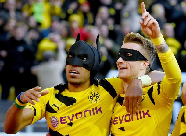 Who needs Pierre-Emerick Aubameyang and Marco Reus when you've got Batman and Robin?<br /><br />Borussia Dortmund's own dynamic duo donned masks after Aubameyang opened the scoring in the Bundesliga match against local rivals Schalke last month.<br /><br />It's not the first time Aubameyang has raided his fancy dress wardrobe after scoring. Earlier this year, he donned a Spiderman mask pulled from his shorts when he netted against Bayern Munich. 
