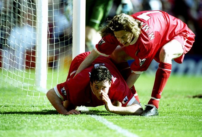 Another up-yours to purported excess.<br /><br />Robbie Fowler of Liverpool is pulled away by team mate Steve McManaman after mimicking snorting cocaine along the white paint of the Anfield touchline to mark his first goal in an English Premier League match against Everton in 1999.<br /><br />The celebration seemed to be aimed at abusive Everton fans, although then Liverpool manager Gerard Houllier tried to sidestep the controversy by saying that Fowler was "eating the grass."