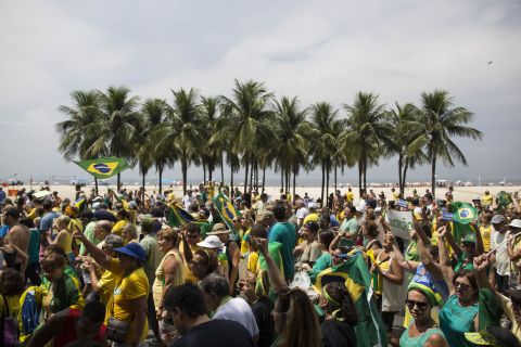 Brazilians march along Copacabana beach. 
